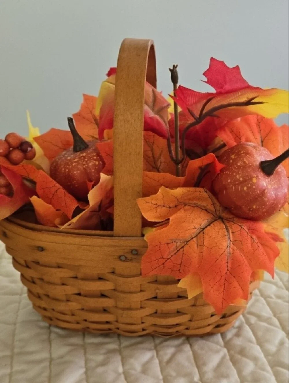 Longaberger woven basket with orange and yellow fall foliage